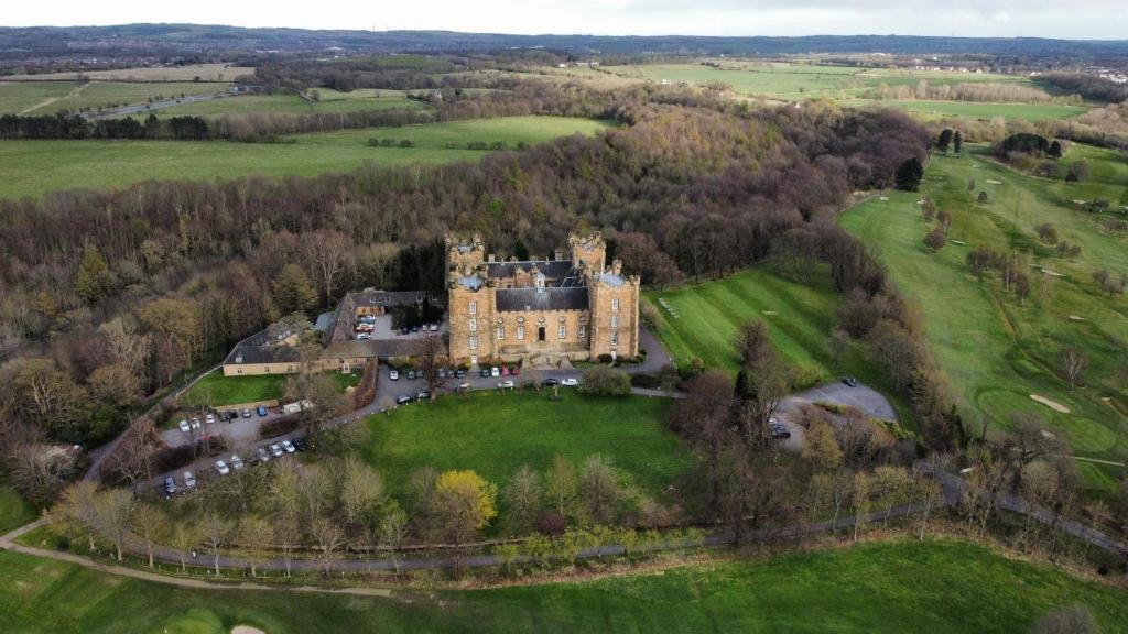 an aerial view of a castle in a field at Lumley Castle Hotel in Chester-le-Street