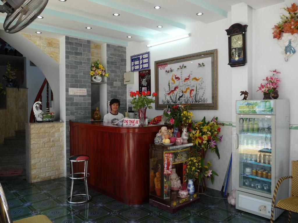 a person standing at a counter in a store at Minh Tai Hotel in Mỹ Tho