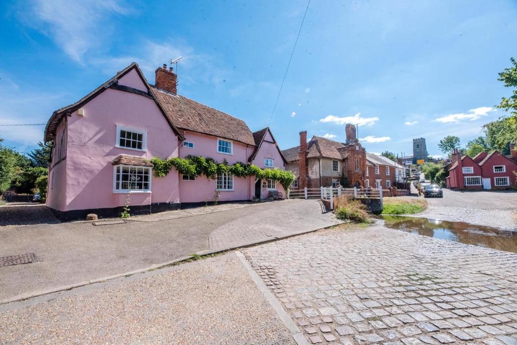 a pink house on the side of a street at Bridge House in Kersey in Ipswich