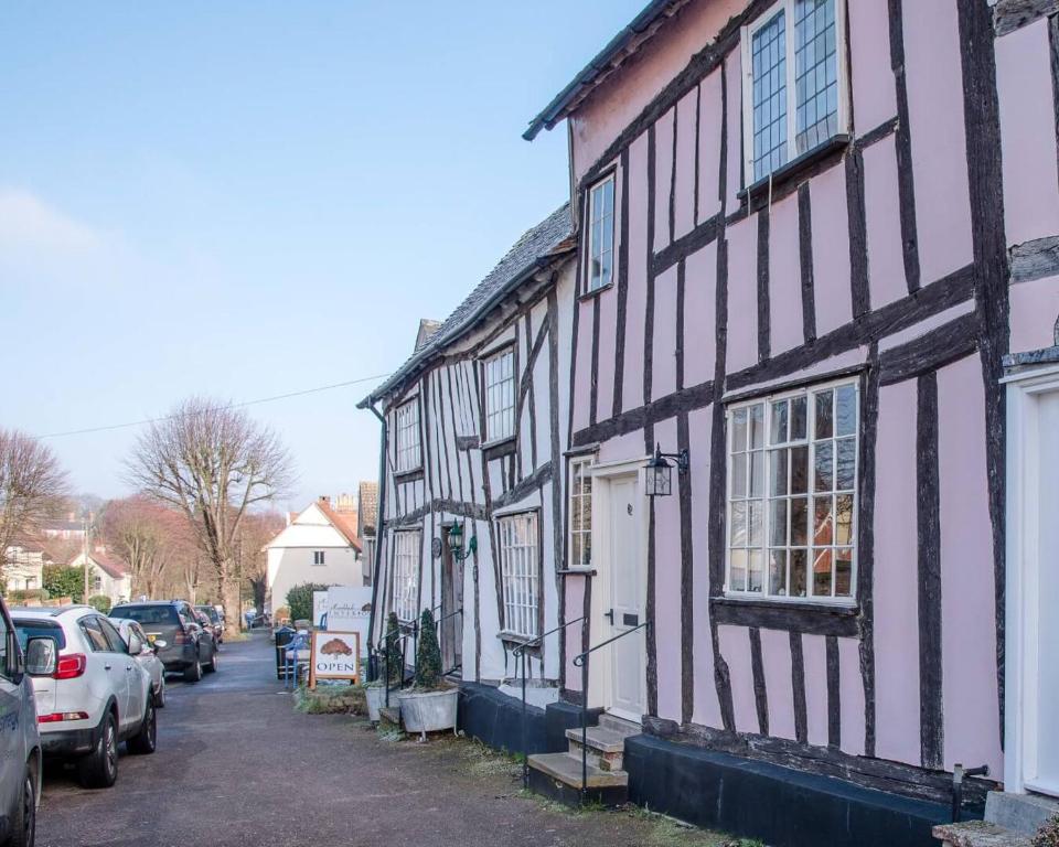 a couple of black and white houses on a street at Rose Cottage in Lavenham in Lavenham