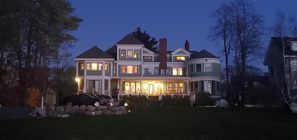 a large white house with its lights on at night at Saltair Inn Waterfront B&B in Bar Harbor