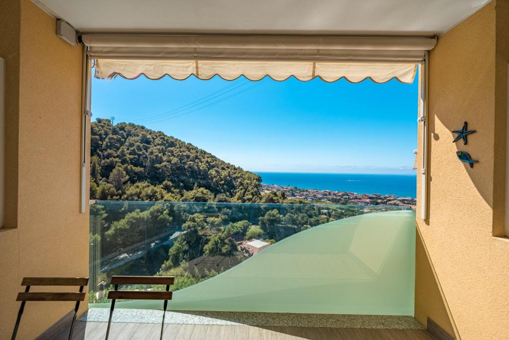 una grande finestra con vista sull'oceano di Appartamento incantevole con piscina a Vallecrosia