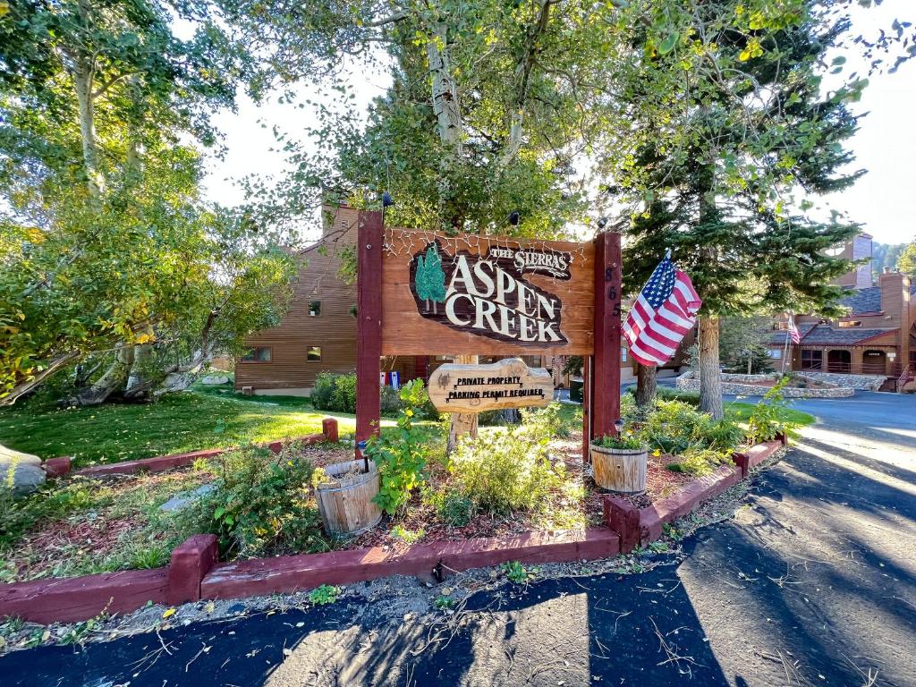 a sign for a sign for a inn on a street at Aspen Creek #115 in Mammoth Lakes
