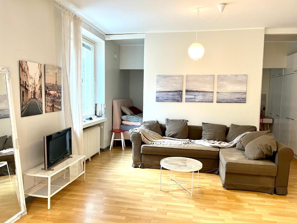 a living room with a couch and a tv at Villa Centralen in Helsinki