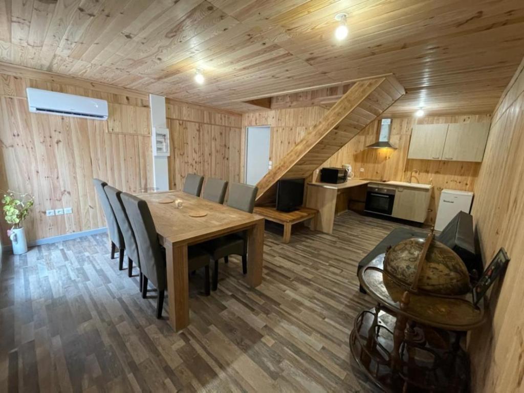 a kitchen and dining room with a table and chairs at Chalet Nala in La Bresse