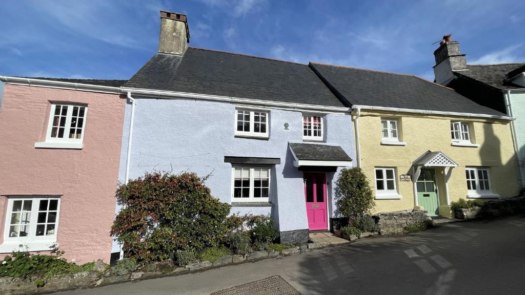 a group of houses with colorful doors on a street at The Nook - Charming cottage, modern living with original features, perfect private garden in Dittisham