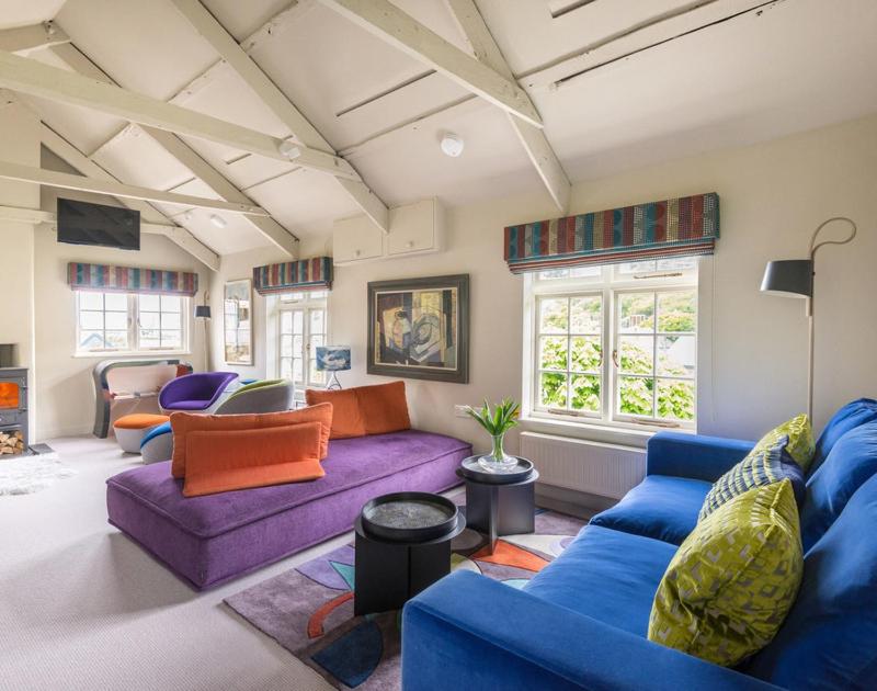 a living room with purple and orange furniture at Crow's Nest in Port Isaac