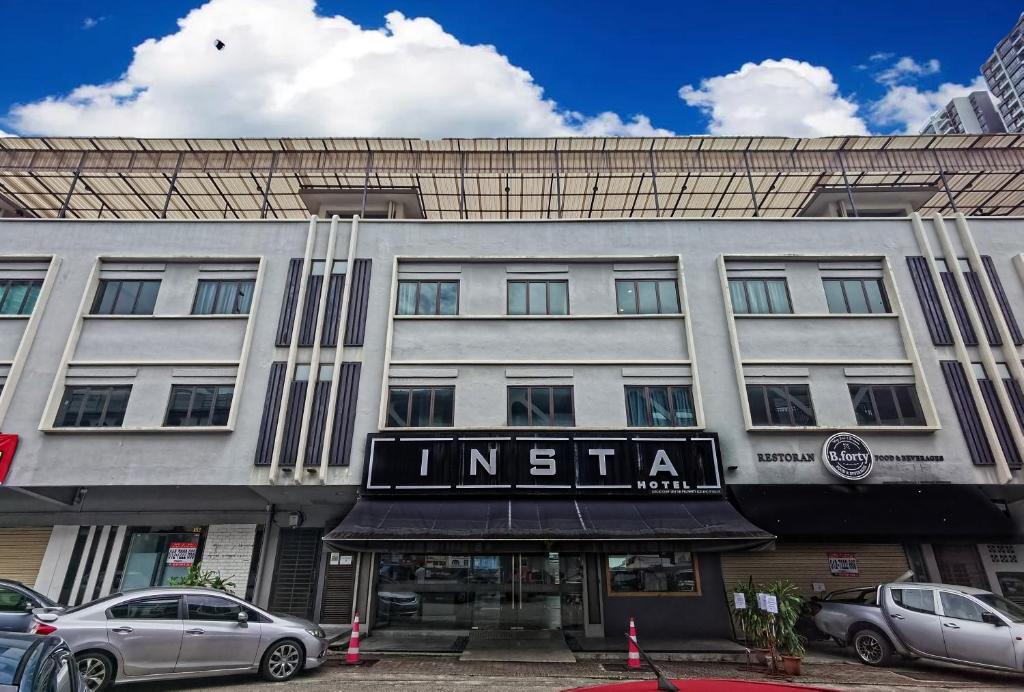 a building with a sign for an institution at Insta Hotel JB in Johor Bahru