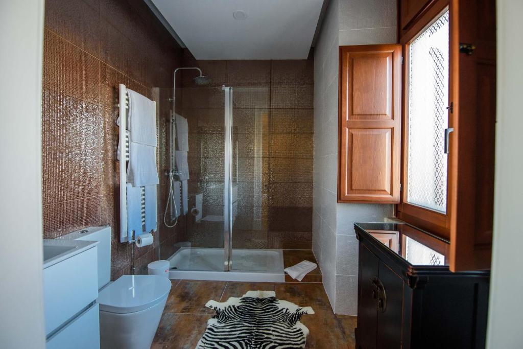 a bathroom with a zebra rug on the floor at Chalet Vitorino in Sintra