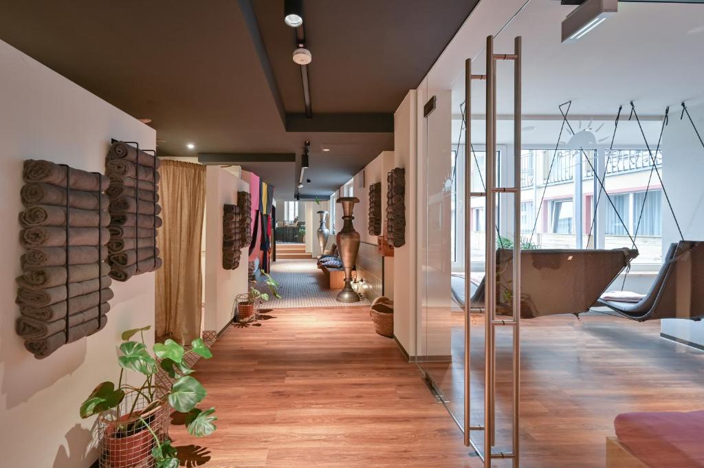 a room with a hallway with a bathtub and a hallway with a room with at Hotel Sonne in Füssen