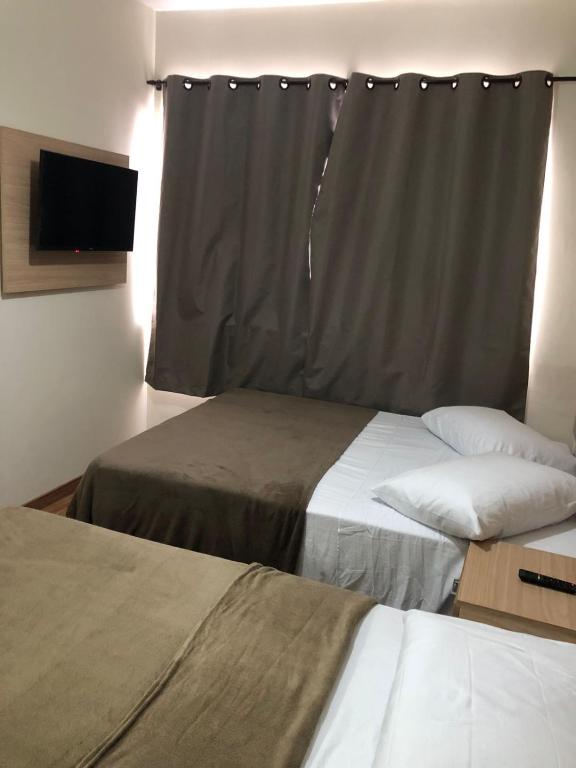 Cama ou camas em um quarto em Pousada HD