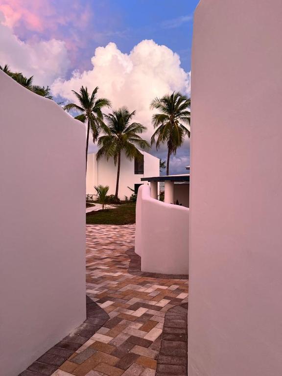 a view of a building with palm trees in the background at OceanBlue Resort in Christ Church