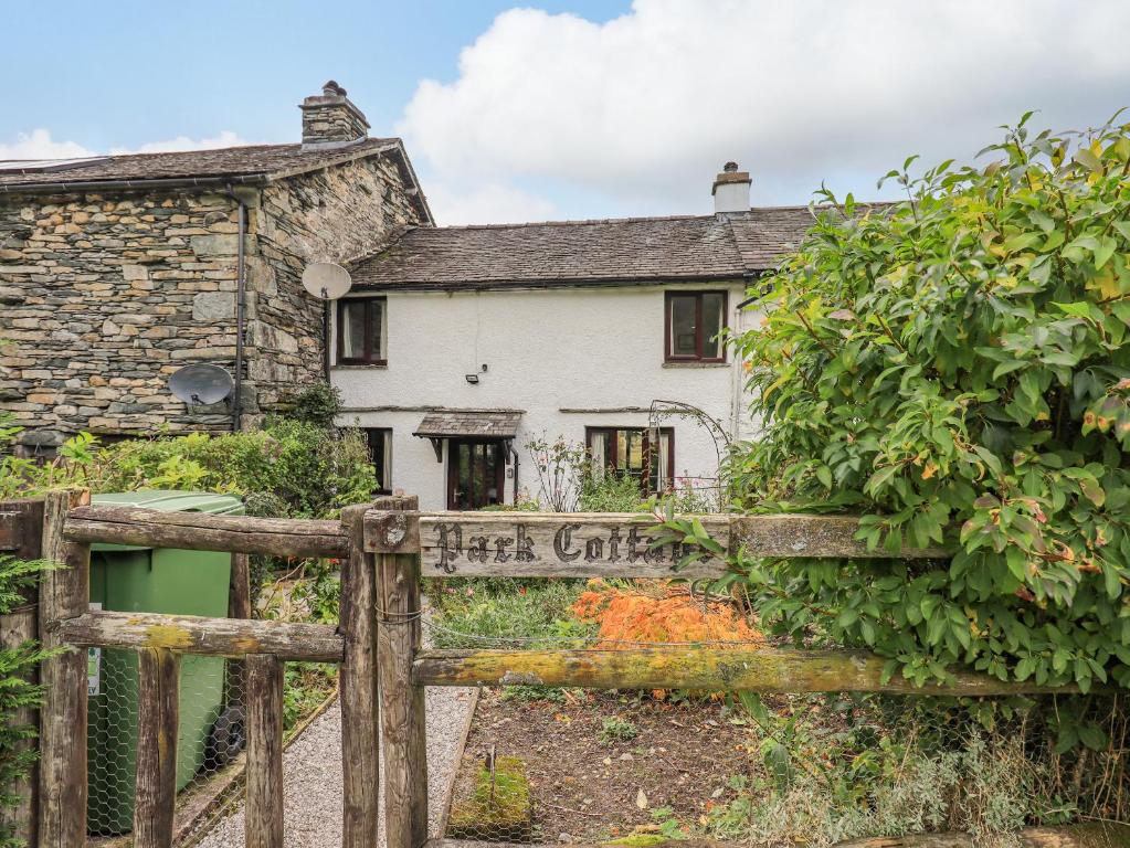 a wooden fence in front of a house at Park Cottage in Ambleside