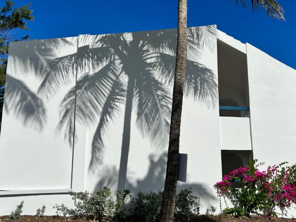 a mural of palm trees on the side of a building at OceanBlue Resort in Christ Church