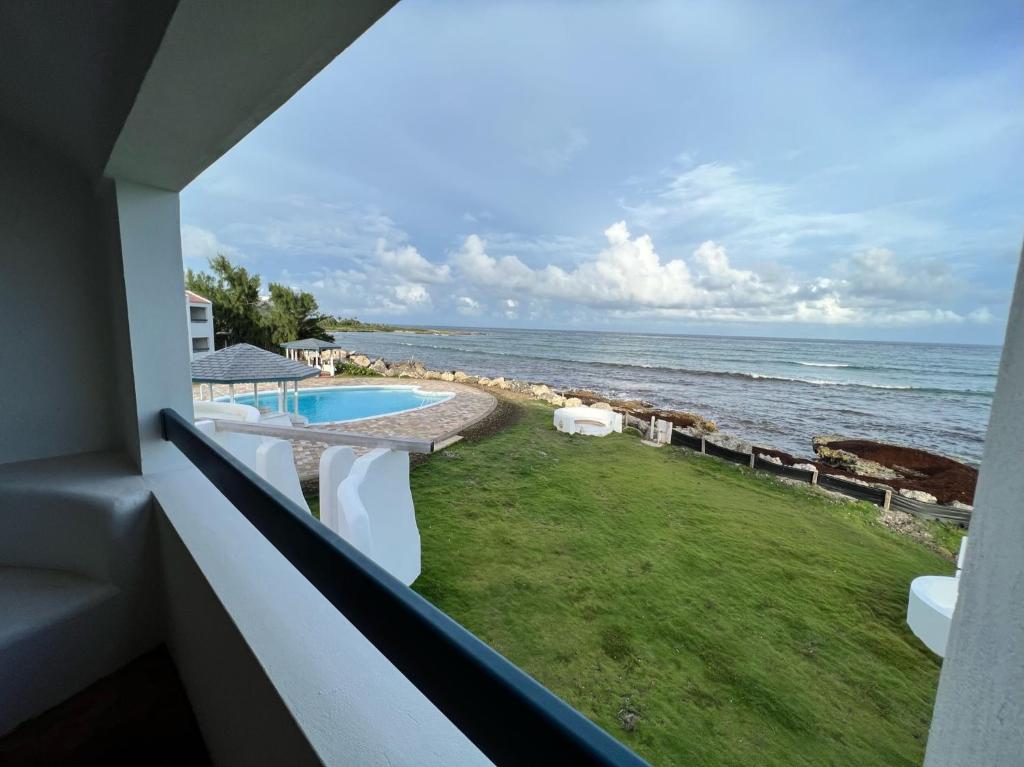 a view of the ocean from the balcony of a resort at OceanBlue Resort in Christ Church