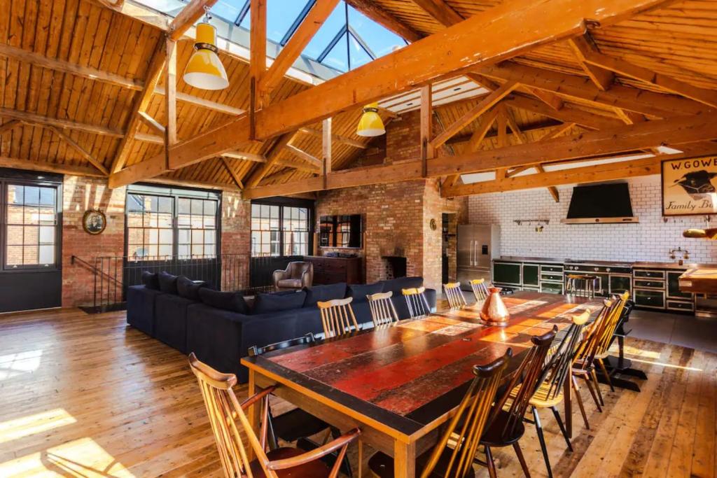 a large dining room with a long table and chairs at Spectacularly Unique 4 Bedroom House in Bethnal Green in London