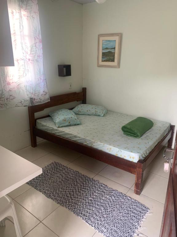 Una cama o camas en una habitación de Hospedagem Entre Marés