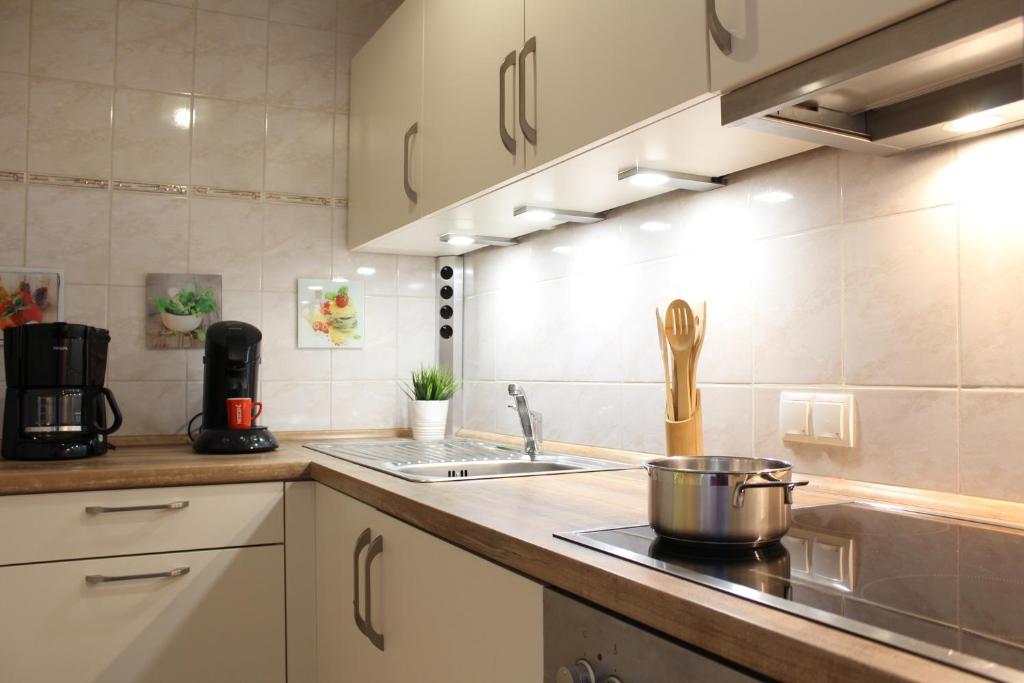 a kitchen with a sink and a stove top oven at Ferienwohnung Krohn Cuxhaven in Cuxhaven