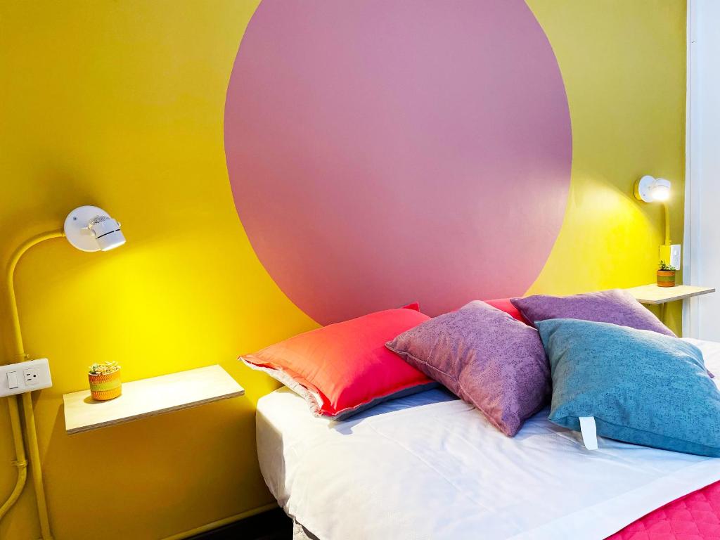 a bed that has a pink blanket on it at Hostal Macondo Bogotá in Bogotá