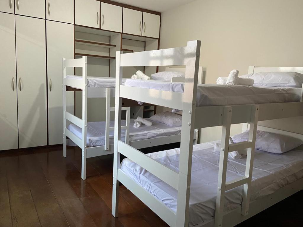 a room with three bunk beds in a room at Hostel Salvador Orquídeas in Salvador