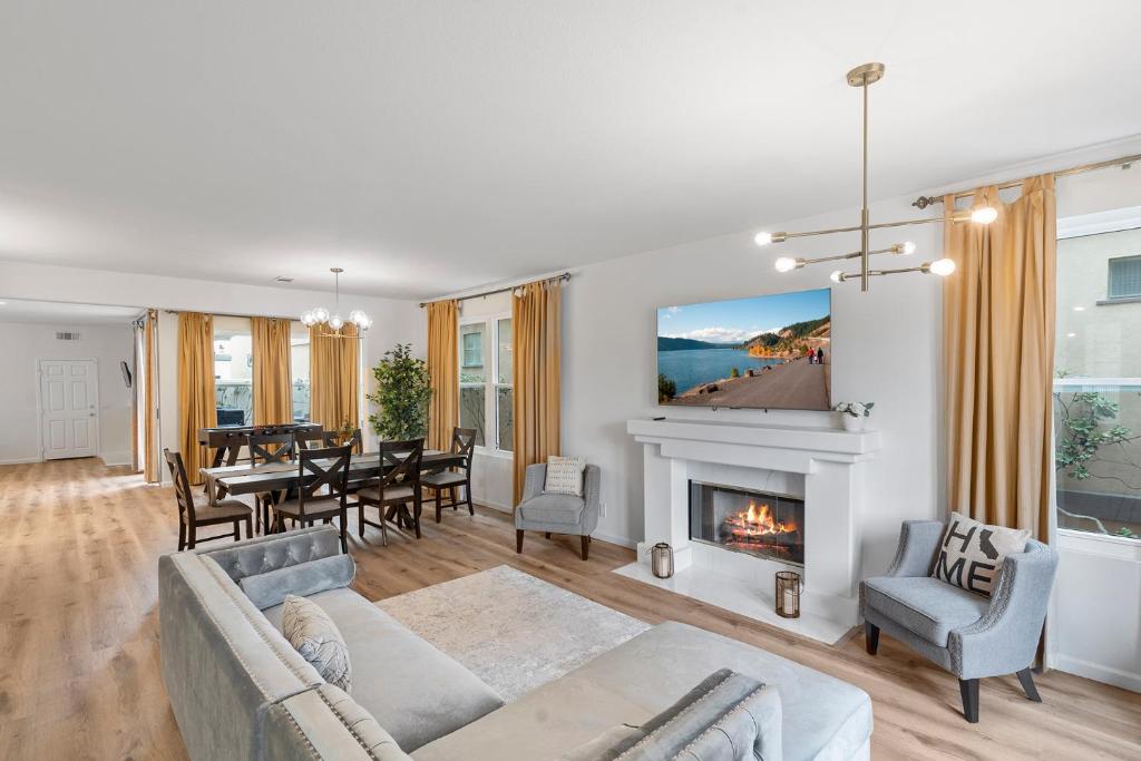 a living room with a couch and a fireplace at The Goldenwest Ocean view home w jacuzzi AC Bikes newly remodeled in Huntington Beach