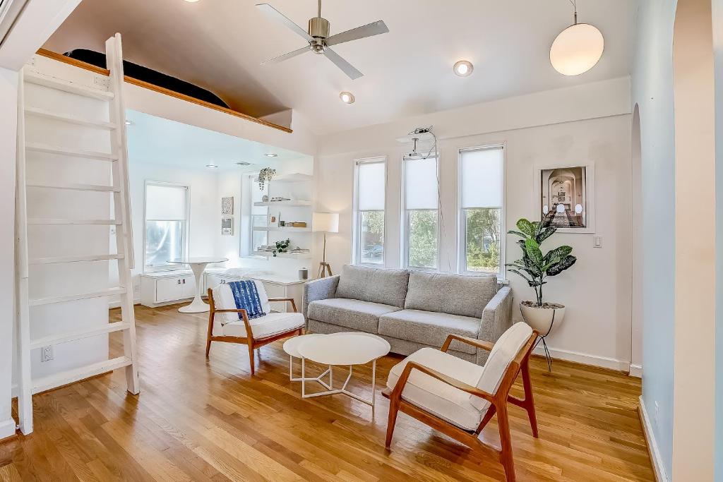 a living room with a couch and a table and chairs at Earn Your Vacation Stripes in Austin