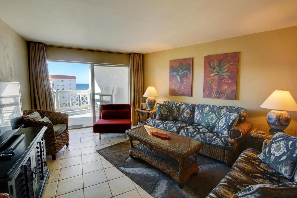 a living room with a couch and a table at El Matador 165 - Beautiful unit with great view of the Gulf in Fort Walton Beach