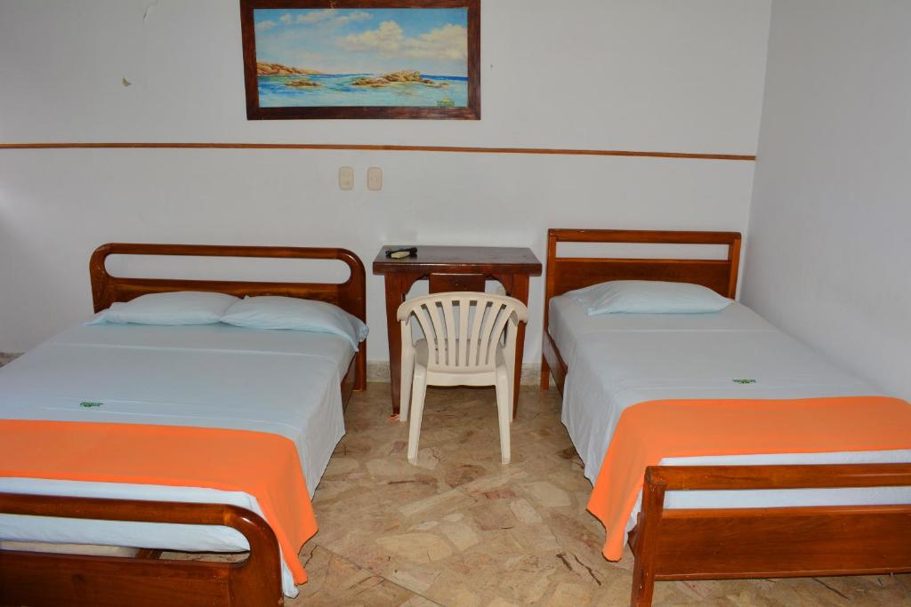Postel nebo postele na pokoji v ubytování Hotel Tayrona