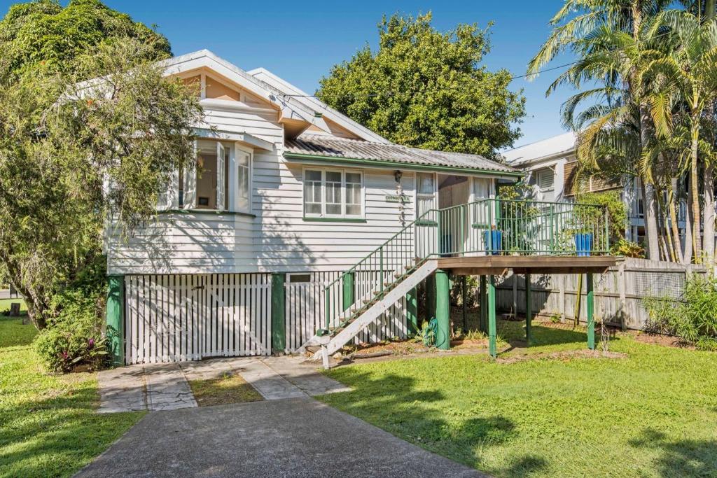 a house with a deck and a fence at Choongurra in Noosaville