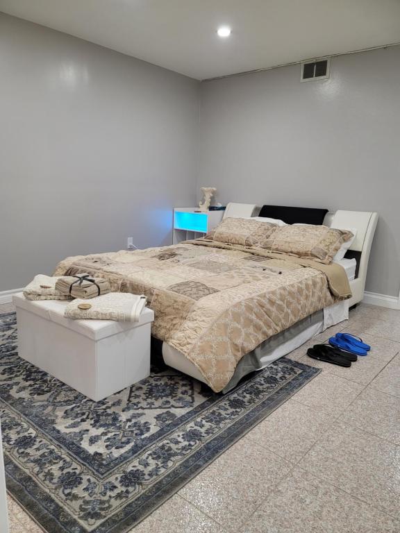 a bedroom with a large bed and a rug at Falstaff Home in Toronto