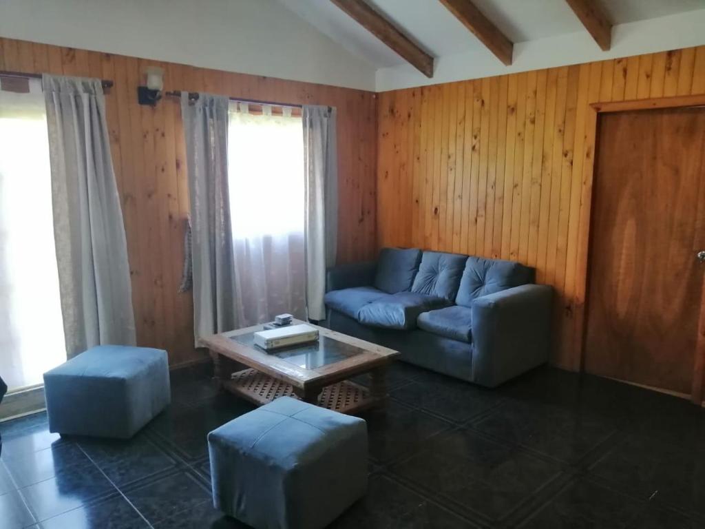 a living room with a couch and a coffee table at Alojamiento Freire - Caviahue in Freire