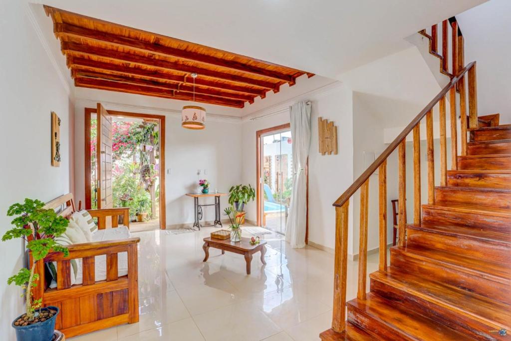 a living room with a staircase and a table at Pousada Canto de Zul in Itacaré