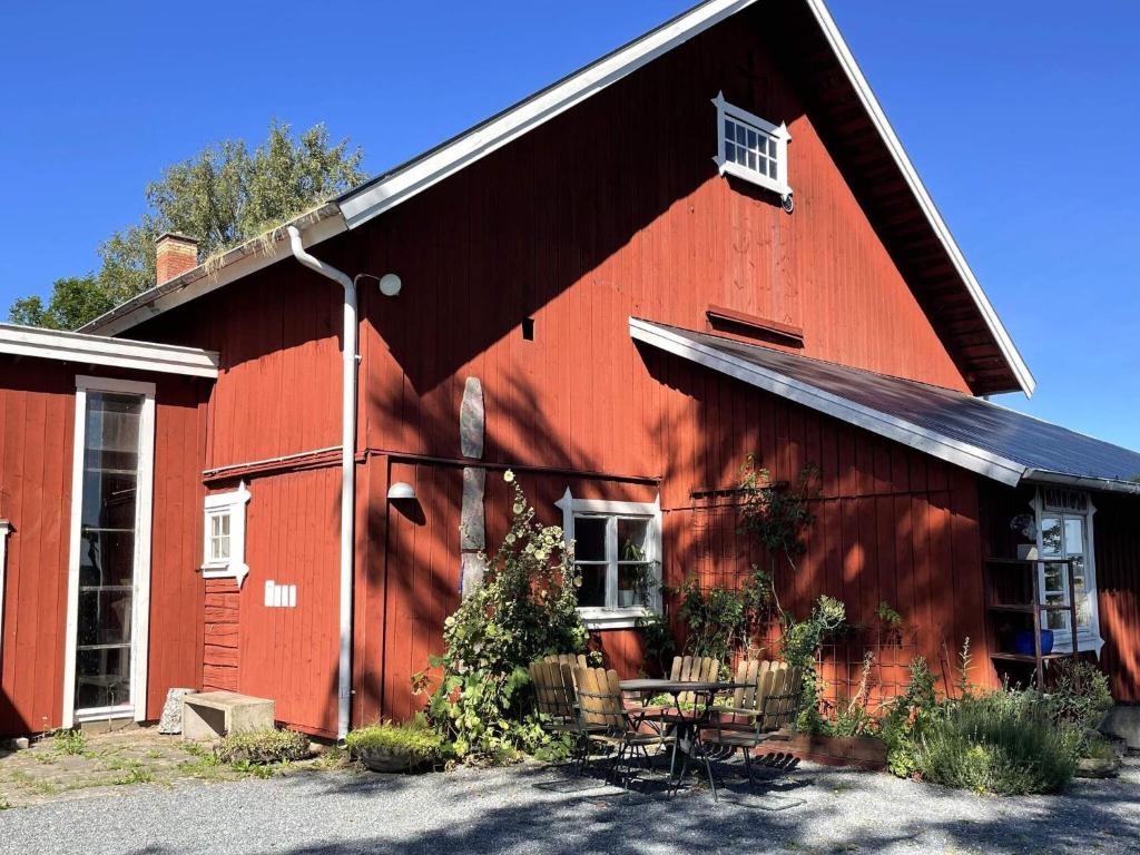a red barn with tables and chairs in front of it at 9 person holiday home in LIDKÖPING-By Traum in Lidköping