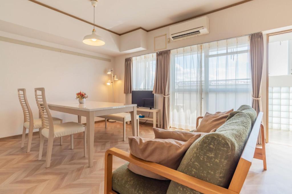 een woonkamer met een bank en een tafel bij Universal Bay Condominium in Osaka