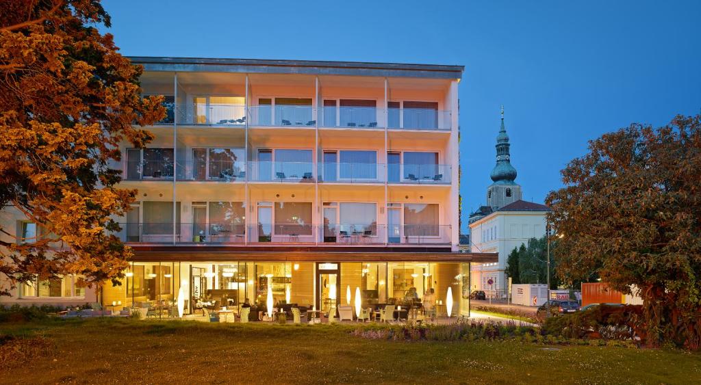a large building with tables and chairs in front of it at At the Park Hotel in Baden