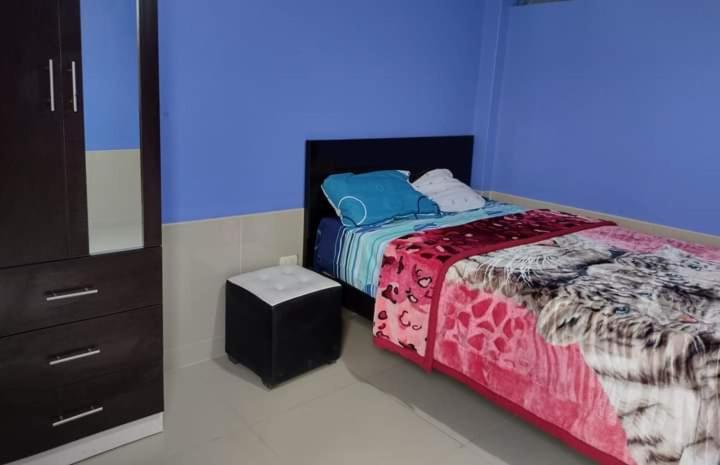 a bedroom with a bed and a dresser in a room at HOSPEDAJE NELLY in Puerto Chicama