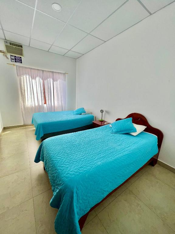 Postel nebo postele na pokoji v ubytování Hostal Punta Arena