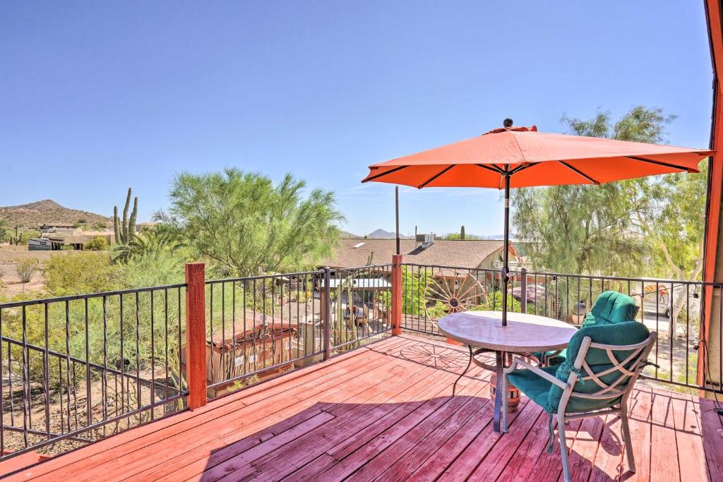 un patio con una mesa y una sombrilla en una terraza en Dreamy Desert Studio with Deck and Pool Access! en Phoenix