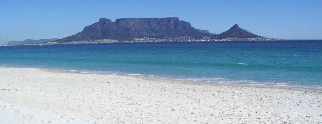 a view of a beach with a mountain in the background at Big Bay Beach Club 134 in Bloubergstrand