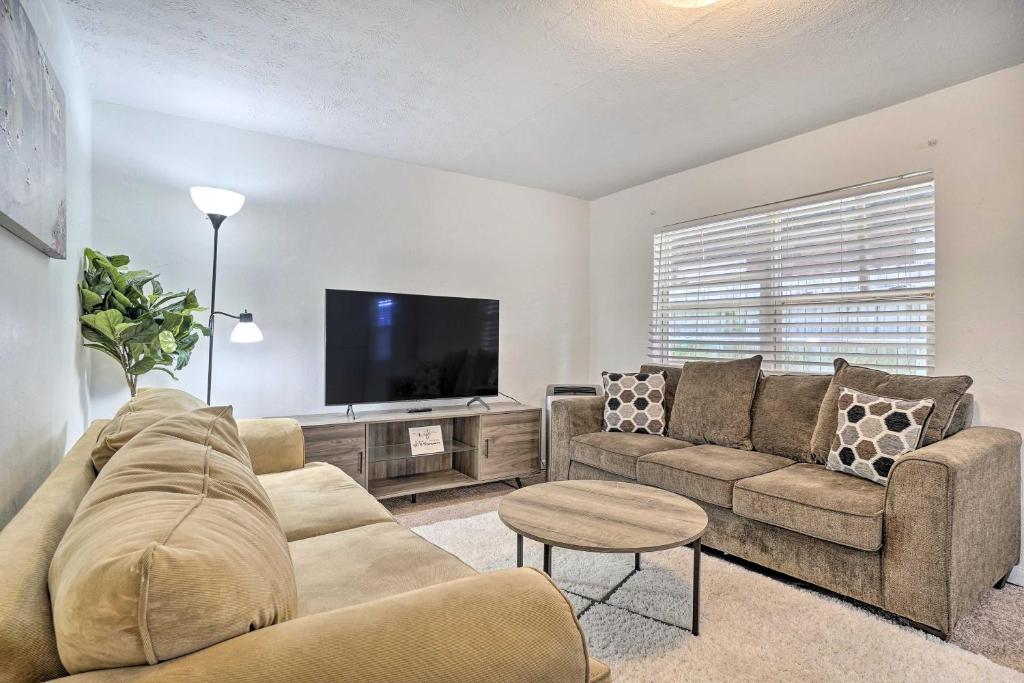 a living room with a couch and a flat screen tv at Low-Key Columbus Apartment - Great Location! in Columbus