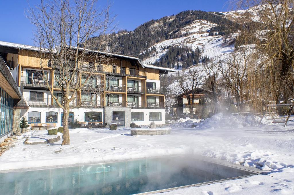 a resort in the snow with a swimming pool at Rauriserhof 4 Sterne Superior in Rauris