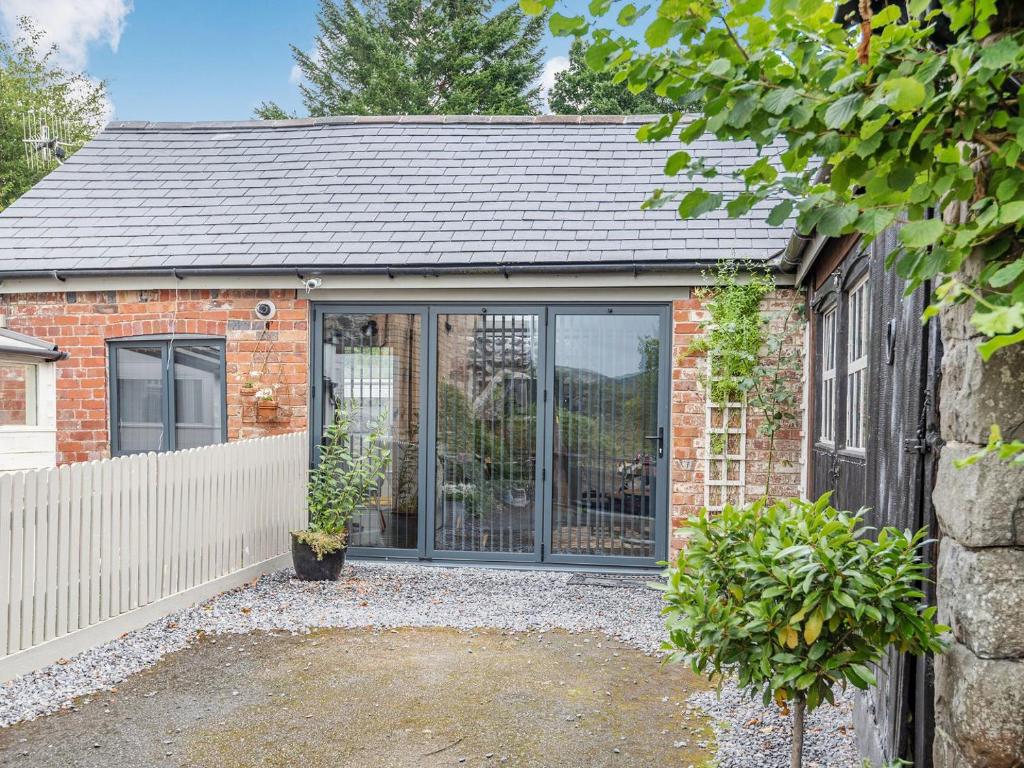 a brick house with a large glass door at The Barn in Newbridge on Wye