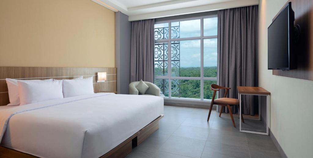 Postel nebo postele na pokoji v ubytování Hotel Santika Gunungkidul