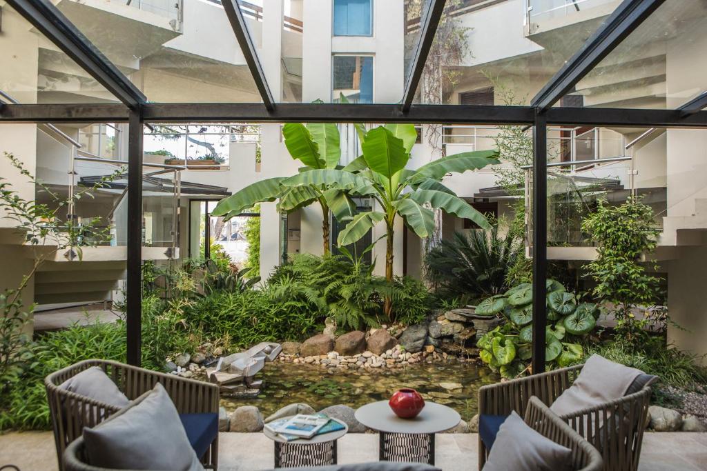 an internal courtyard with a garden in a building at Hôtel La Roya in Saint-Florent