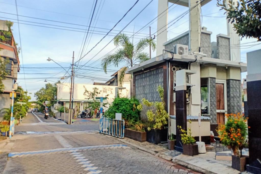 an empty street in a city with a building at Graha Asri Syariah in Waru