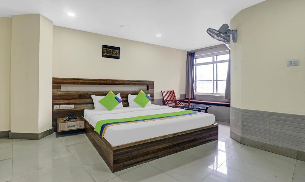 a bedroom with a large bed in a room at Treebo Trend Darwesh Residency in Kozhikode