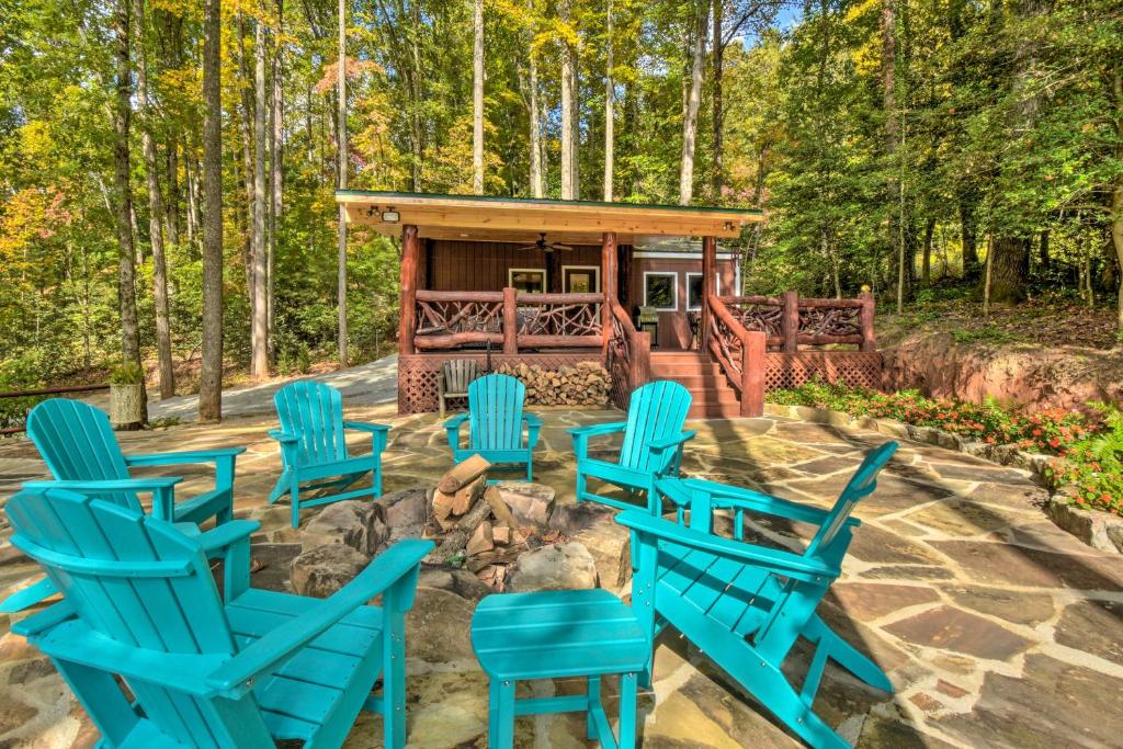a group of blue chairs in front of a fire pit at Clayton Retreat with Spacious Deck and Mtn Views! in Clayton