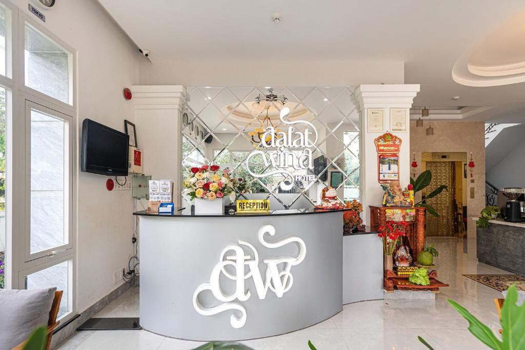 a restaurant with a counter with a sign on it at Dalat Wind Hotel in Da Lat