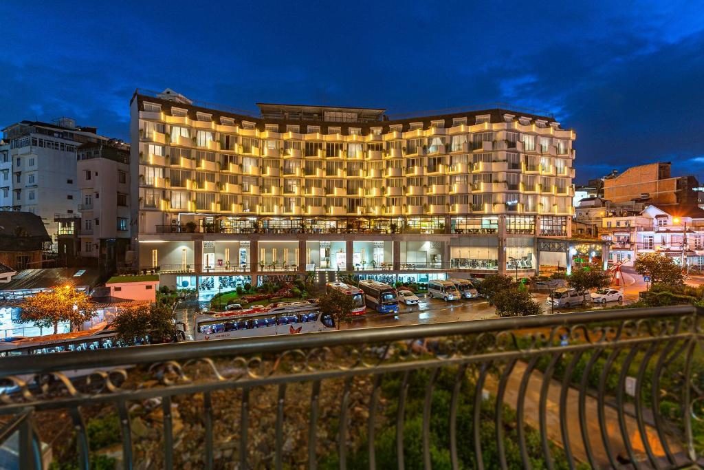 a large building in a city at night at Dalat Wind Hotel in Da Lat