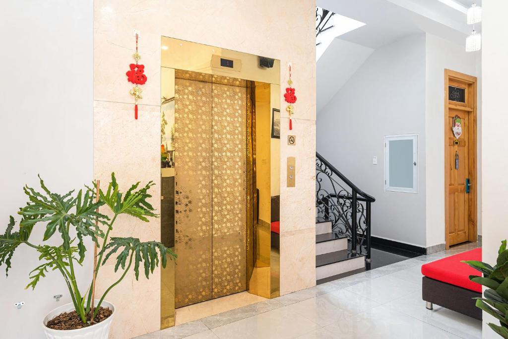 a door in a room with a plant at Dalat Wind Hotel in Da Lat